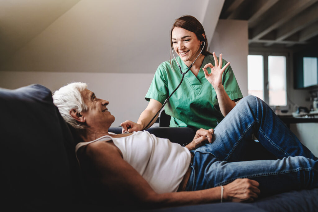 Young Female Doctor In Health Care Home Visit Said Ok To Elderly